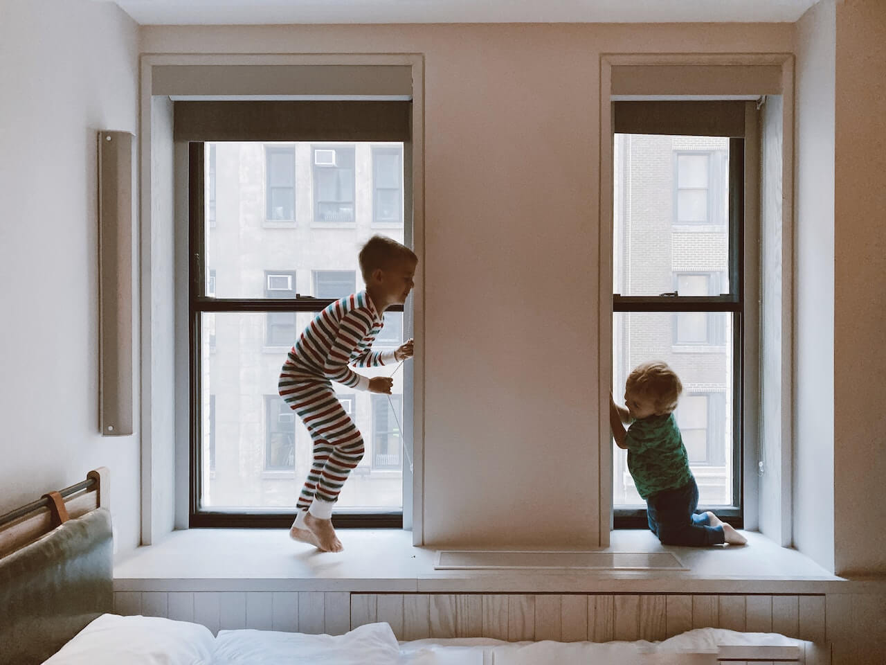 Kids playing in their room by the window.